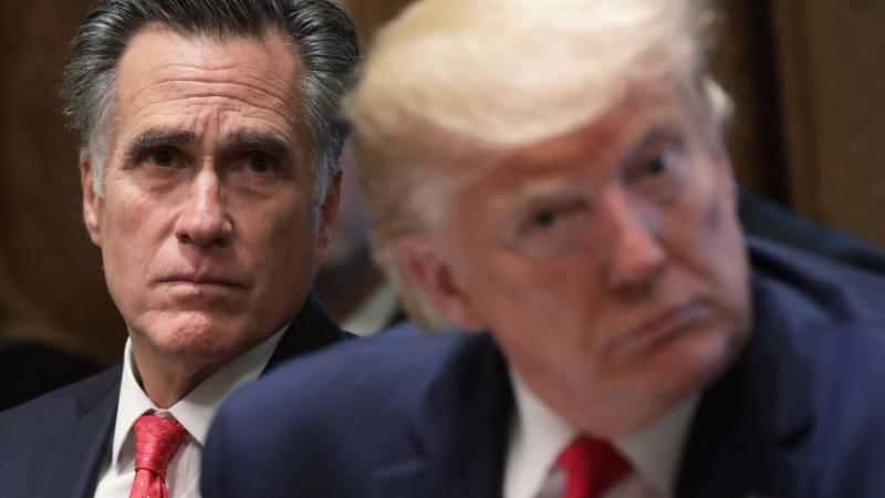 Mitt Romney sits behind President Trump during a listening session in the Cabinet Room