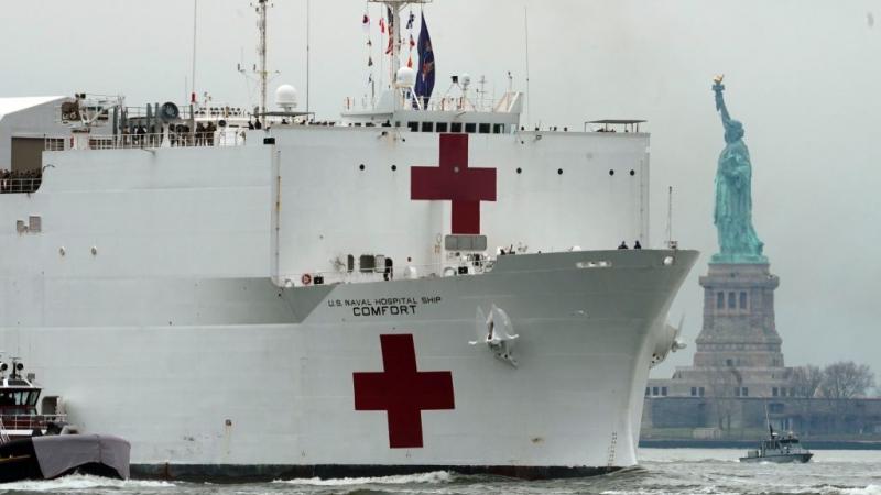 USNS Comfort medical ship passes the Statue of Liberty as it arrives in New York harbor on March 30, 2020