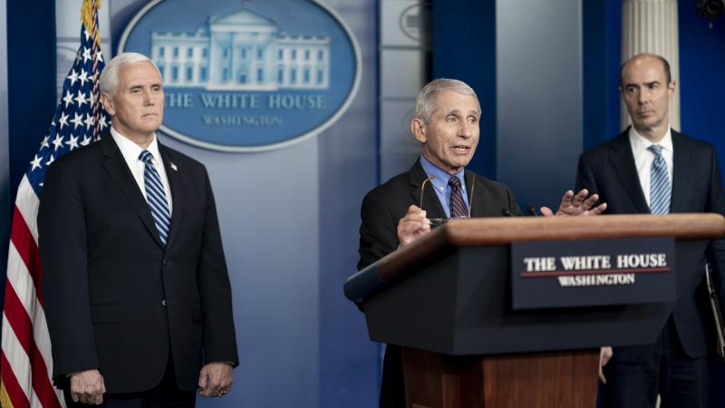 Vice President Mike Pence and Labor Secretary Eugene Scalia listen as Director of the National Institute of Allergy and Infectious Diseases Dr. Anthony S. Fauci delivers remarks during a coronavirus update briefing Wednesday, April 8, 2020