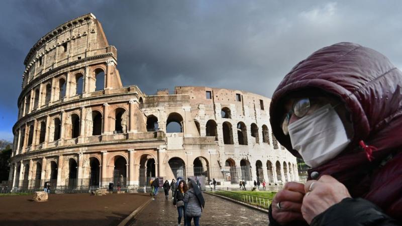 Man wearing mask near Coliseum in Rome on March 7, 2020