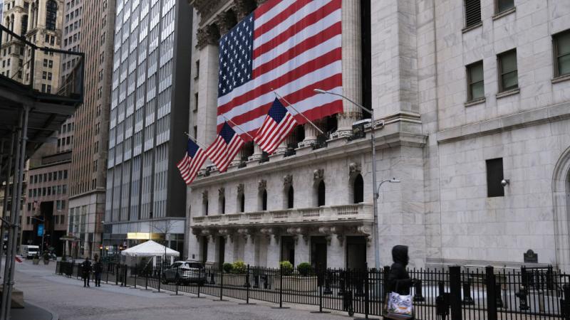 Person walking on Wall Street on April 27, 2020