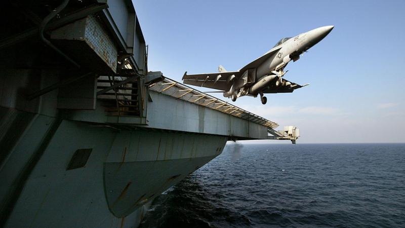 An F/18 Super Hornet is launched from the deck of the USS Abraham Lincoln