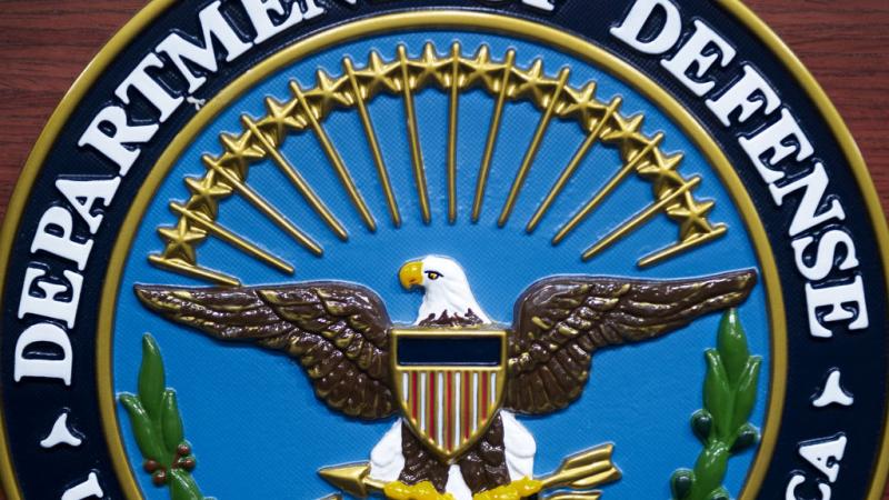 Department of Defense seal on a lecturn in 2013