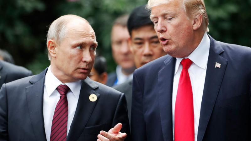 President Trump and President Putin converse at an APEC meeting in 2017
