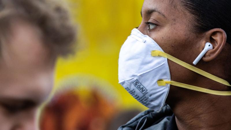 A New York City woman wearing a mask