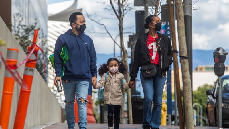 A family in Los Angeles wearing masks