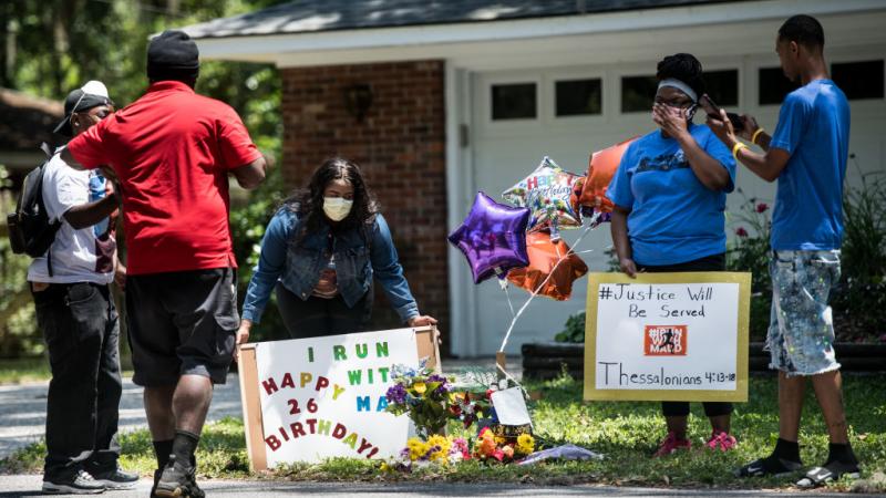 Demonstrators hold a memorial for Ahmaud Arbery