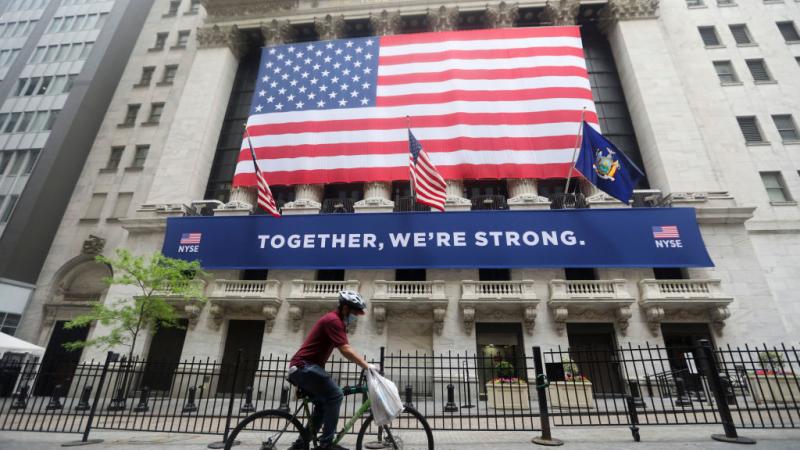 Cyclist passing New York Stock Exchange on May 26, 2020