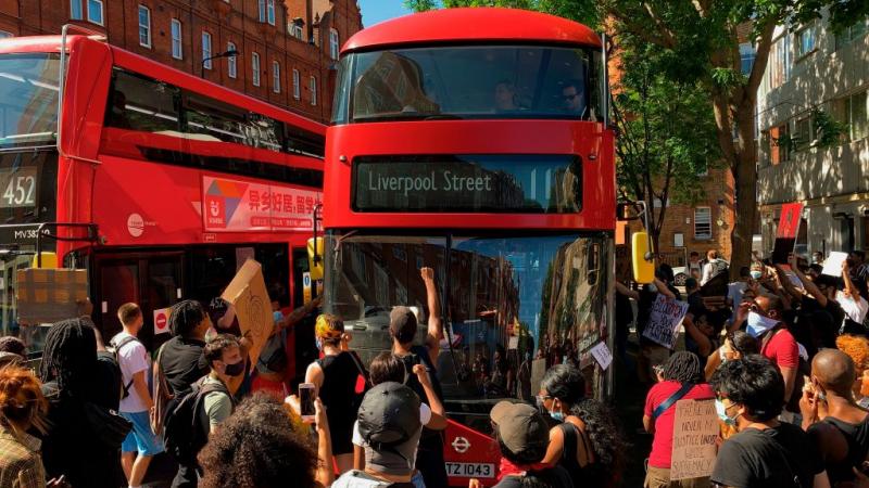 Demonstrators stop a bus in London on May 31, 2020