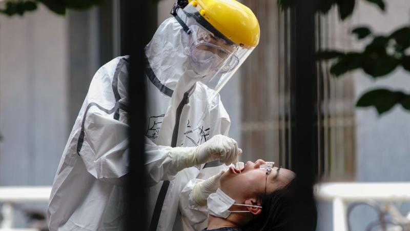 A Beijing resident gets tested for coronavirus