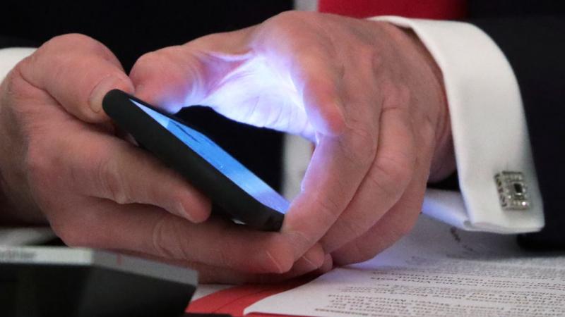 President Trump holding a phone on June 18, 2020