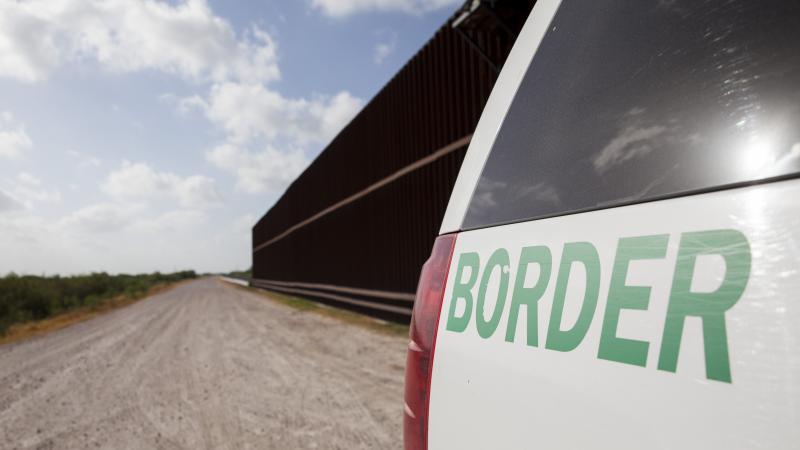 A Customs and Border Protection vehicle patrols the border wall in Rio Grande Valley sector of the Texas border.