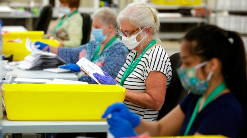 Election workers checking ballots in Washington state, Aug. 4