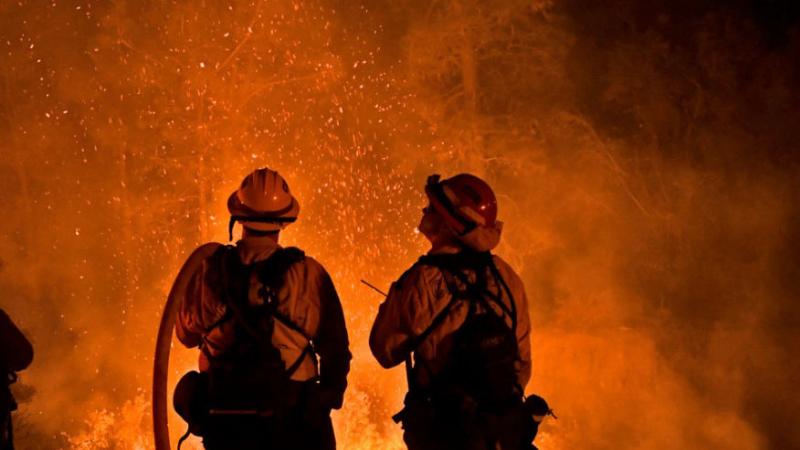 Firefighters battling a blaze near Lake Hughes, California on August 15, 2020
