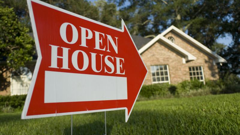 An open house sign outside of a home for sale