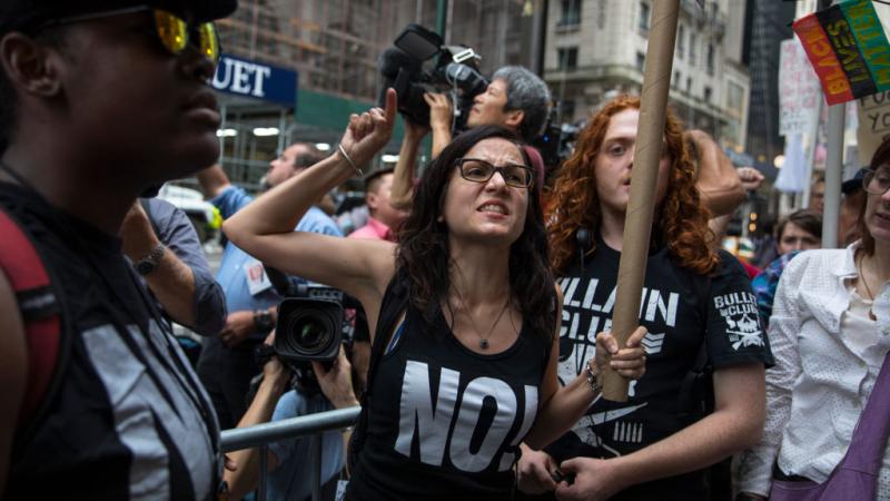 NEW YORK, NY - AUGUST 14, 2017: Sunsara Taylor, center, leads protesters from RefuseFascism.org outside of Trump Tower August 14, 2017 in New York City. 