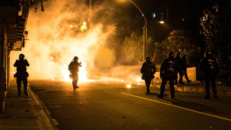 Demonstrators clash with riot police during a protest to denounce police brutality in Medellin, Colombia on September 10, 2020. 