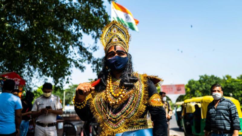 An officer from the District Magistrate Office dressed as Hindu lord of death and justice in India