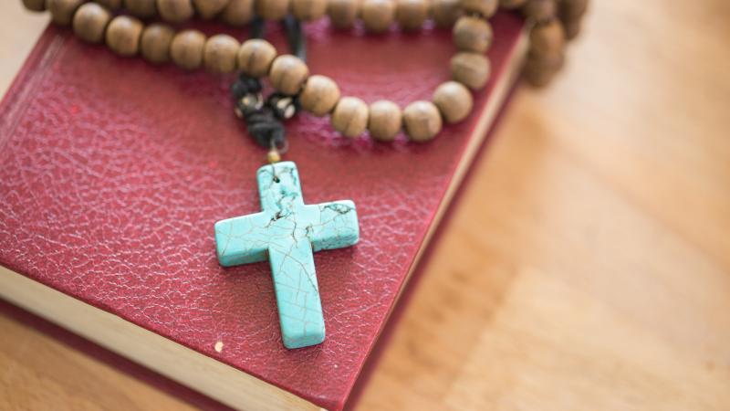A Bible with a rosary