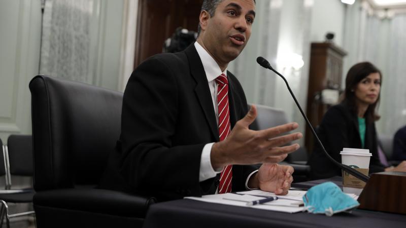Chairman of Federal Communications Commission Ajit Pai (L) testifies as commissioner of Federal Communications Commission 