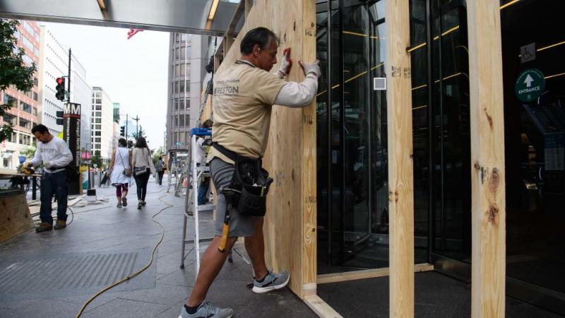 D.C. businesses boarding up windows 