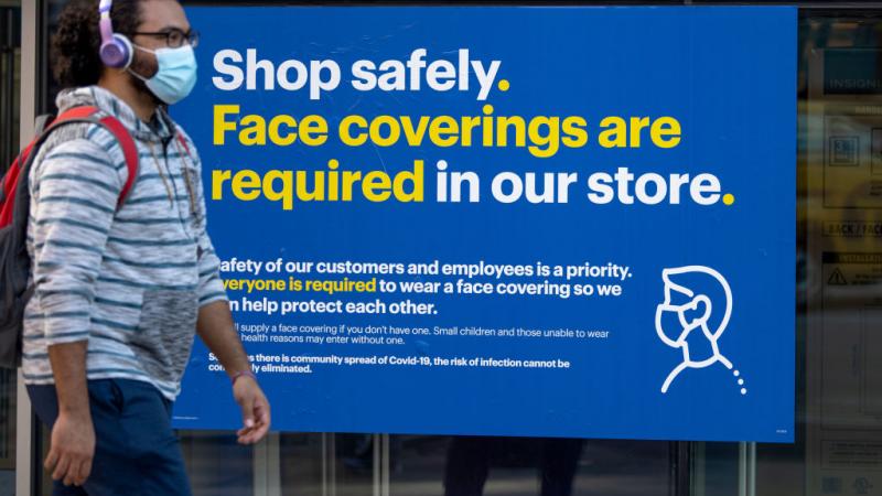 A mask policy sign outside of a Best Buy in New York City