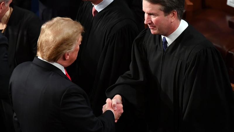 US President Donald Trump shakes hands with US Supreme Court Justice Brett Kavanaugh before delivering the State of the Union address at the US Capitol in Washington, DC, on February 5, 2019. 