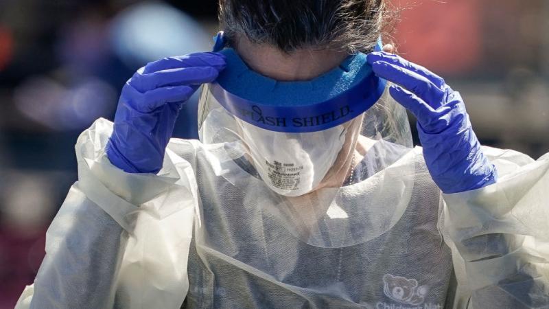 Person working at coronavirus drive-thru testing site in Washington DC in April 2020