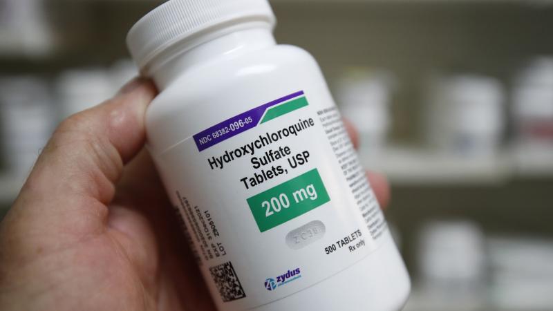 A pharmacy tech holds a bottle of Hydroxychloroquine at Rock Canyon Pharmacy in Provo, Utah, on May 20, 2020.