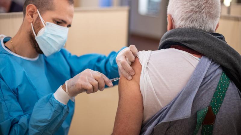 A patient gets a vaccine shot in Milan, Italy