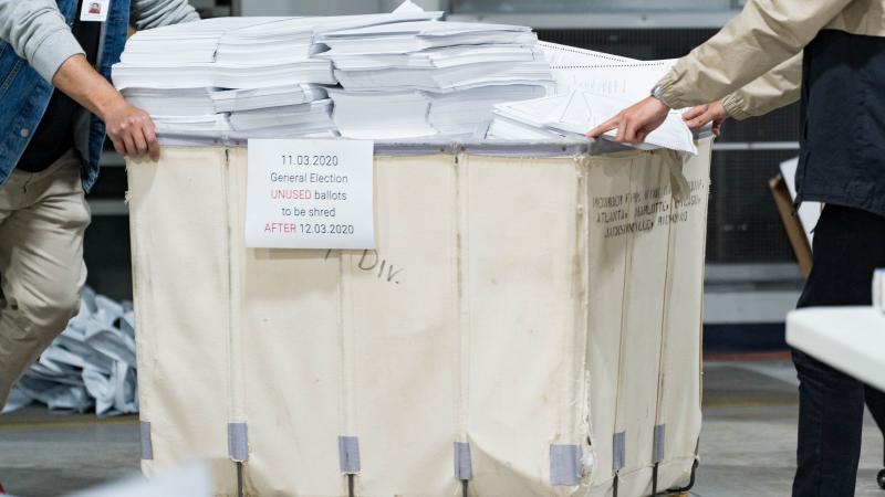 Gwinnett county workers begin their recount of the ballots on November 13, 2020 in Lawrenceville, Georgia.