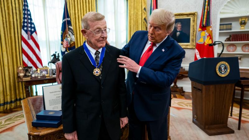 Trump presents Medal of Freedom to Lou Holtz in Oval Office.