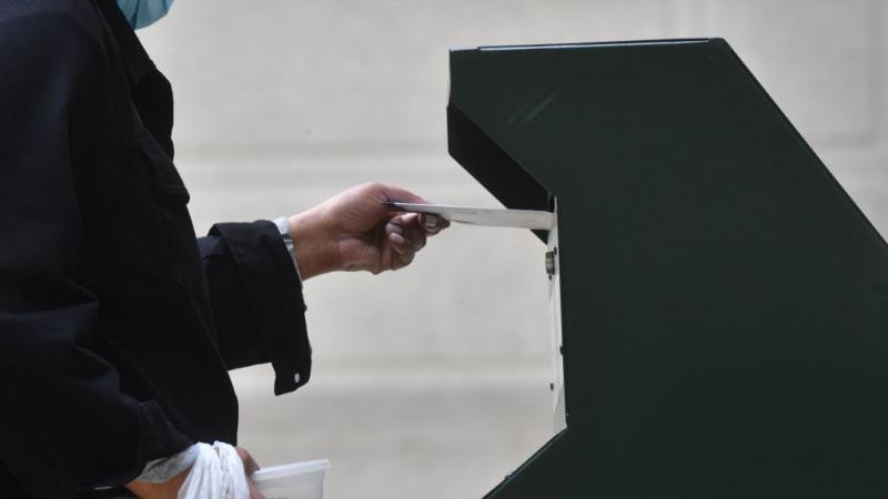Woman putting ballot in drop box in Philadelphia in Oct. 2020