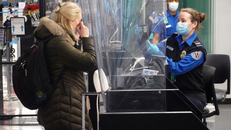 TSA employee checks passengers identity at O'Hare International Airport