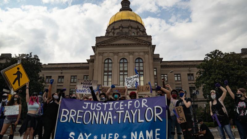Demonstrators at a memorial for Breonna Taylor
