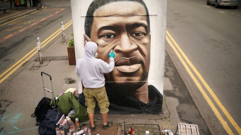 Graffiti artist Akse spray paints mural of George Floyd in the United Kingdom in 2020