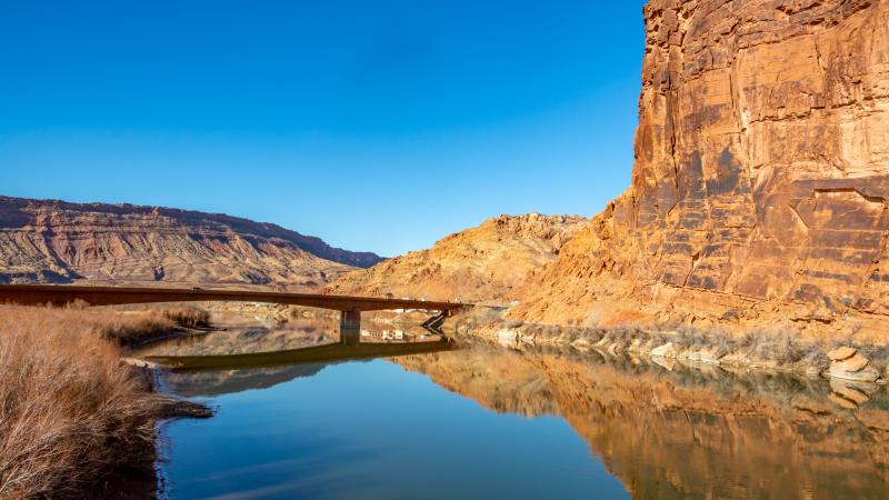 View of the highway bridge across the Colorado River near Lion's Park on the Moab Canyon Trail in Moab, Utah.