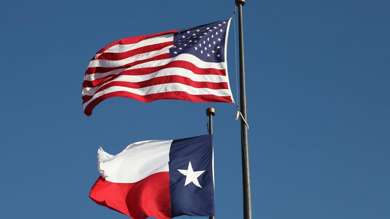 American flag and Texas flag flying at LBJ library in Austin.