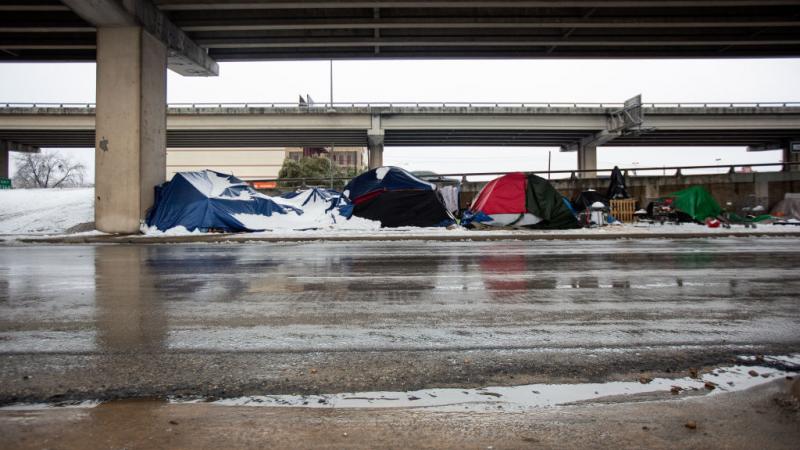 Homeless camps sit along the I-35 frontage road in Austin, Texas on February 17, 2021. 