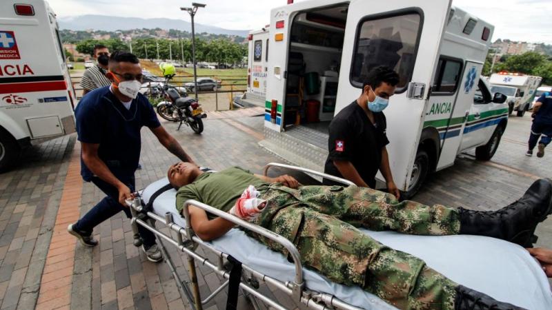 A Colombian soldier receives medical care following an explosion