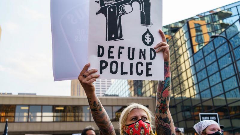 Defund the police sign at a protest 2020.