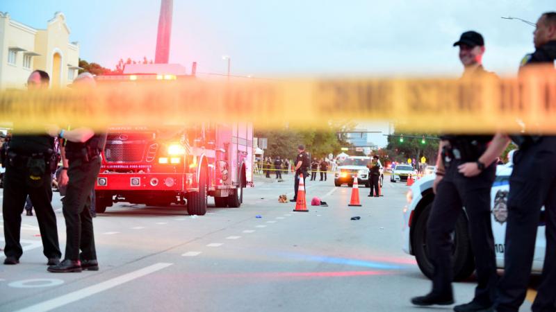 Police investigate scene where pickup drove into people at a pride parade in Florida on June 19, 2021