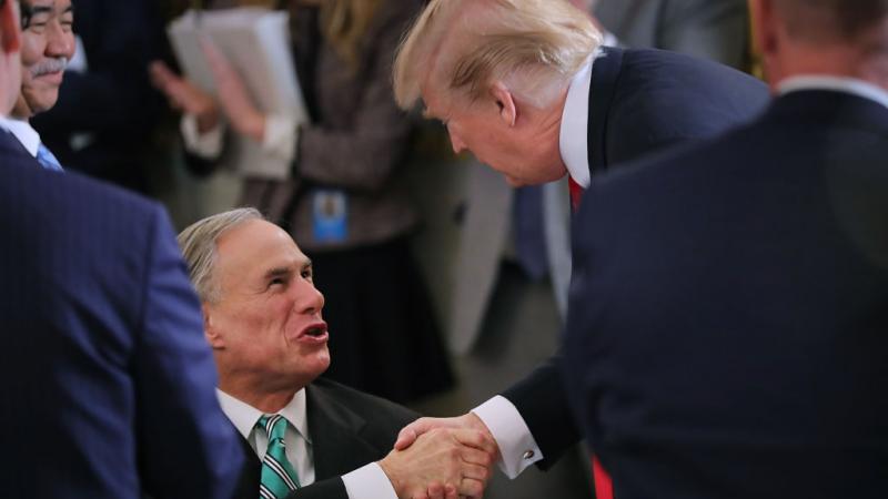 Then-President Trump greets Texas Gov. Greg Abbott in February 2018