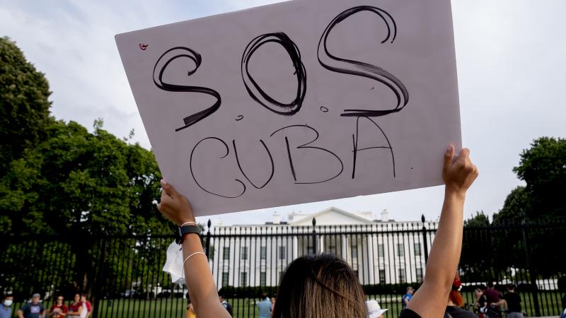 A demonstrator gathers with others in solidarity with protests in Cuba outside the White House on July 18, 2021 in Washington, DC.
