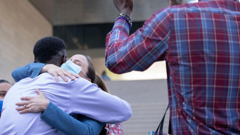 Assistant U.S. Atty. Chelsea Norell hugs surviving victim Dane Brown following Ed Bucks guilty verdict 