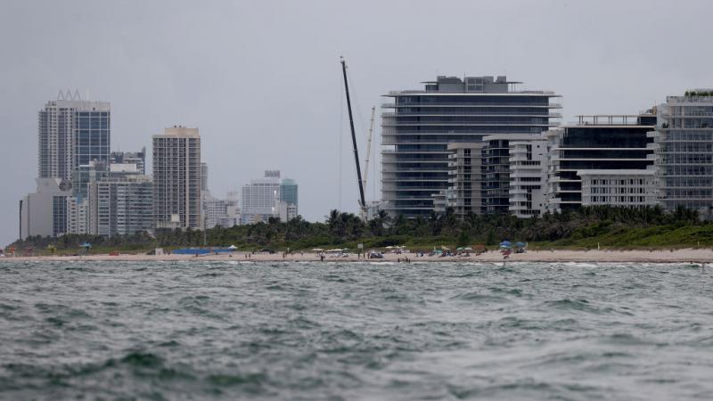 Cranes mark the skyline at the spot where a controlled demolition of the partially collapsed 12-story Champlain Towers South condo took place on July 5, 2021 in Surfside, Florida