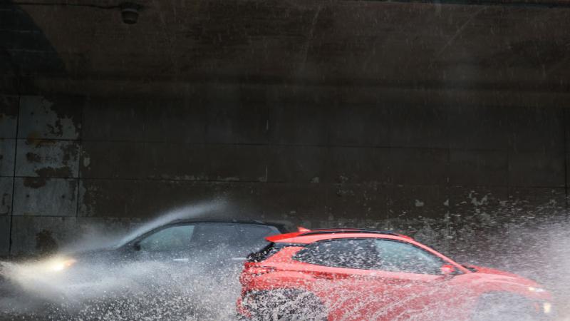 Cars drive through slight flooding in NYC on July 9.
