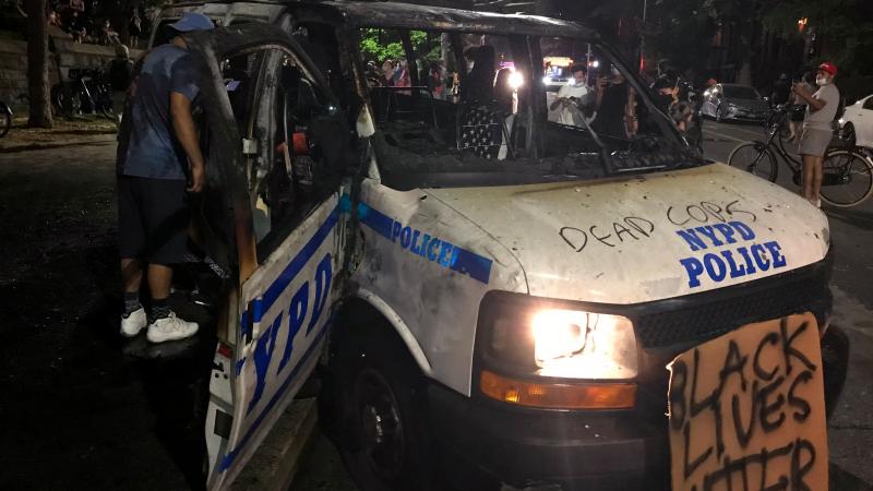 The remains of a scorched police vehicle lie vandalized during riots in the Fort Greene neighborhood in the Brooklyn borough of New York on May 29, 2020.