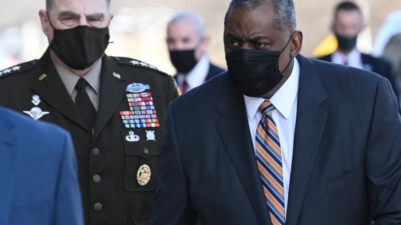 US Secretary of Defense Lloyd Austin arrives at the Pentagon as Chairman of the Joint Chiefs of Staff Mark Milley (L) looks on in Washington, DC