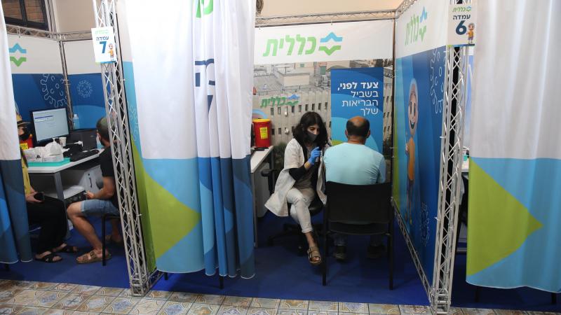 Administration of a third dose of the COVID-19 vaccine at the Clalit Healthcare Maintenance Organization in Jerusalem, Aug. 24